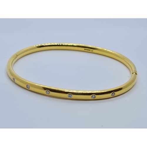 578 - 18ct gold bangle with six small diamonds in a Cartier style weighs 28gm.