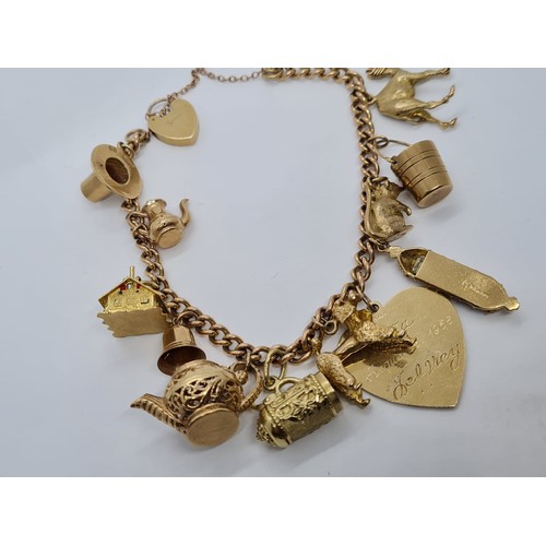 569 - 9ct gold vintage charm bracelet with 12 charms weight 53.3gram 18cm long with heart padlock.