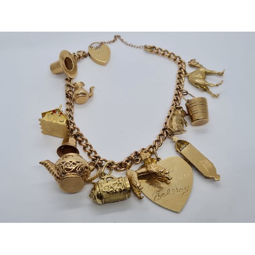 569 - 9ct gold vintage charm bracelet with 12 charms weight 53.3gram 18cm long with heart padlock.