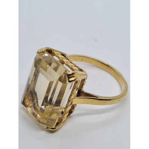 571 - 9ct dress ring with large citrine stone weight 6gm size is O.