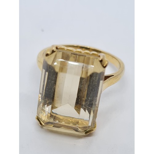 571 - 9ct dress ring with large citrine stone weight 6gm size is O.