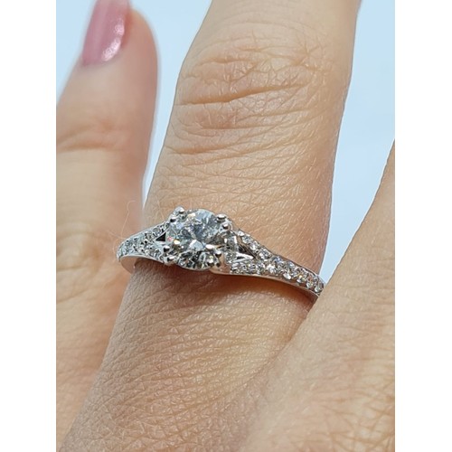 75 - 18CT WHITE GOLD ROUND BRILLIANT DIAMOND SOLITAIRE RING WITH DIAMOND SET SPLIT SHOULDERS, 0.60CT COLO... 