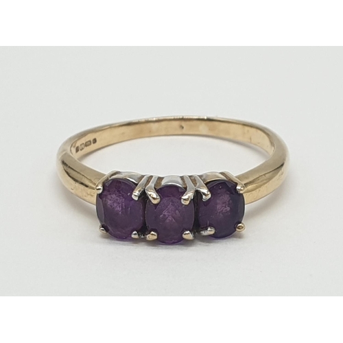 172 - 9ct gold ring having a dark amethyst trilogy to top, boxed full UK hallmark for Birmingham 9ct gold,... 