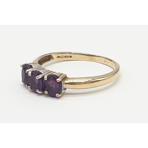 172 - 9ct gold ring having a dark amethyst trilogy to top, boxed full UK hallmark for Birmingham 9ct gold,... 