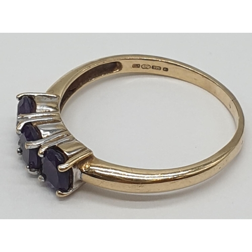 172 - 9ct gold ring having a dark amethyst trilogy to top, boxed full UK hallmark for Birmingham 9ct gold,... 