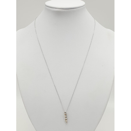 246 - 18k gold and diamond set pendant on a 9ct gold 45cm long chain, weight 1.4g and pendant 15mm long