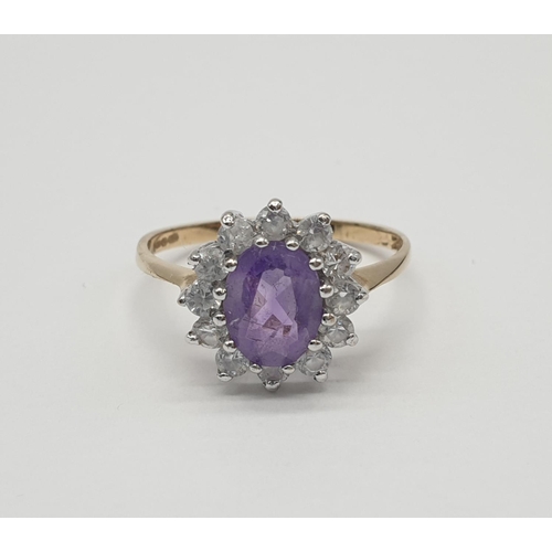 353 - 9ct gold ring having oval shaped faceted amethyst to top with clear stone surround, inclusion to ame... 