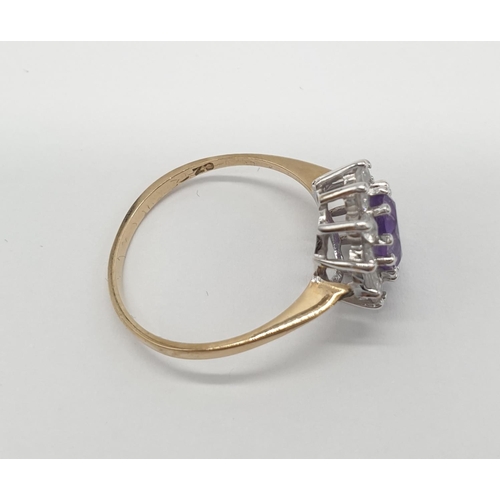 353 - 9ct gold ring having oval shaped faceted amethyst to top with clear stone surround, inclusion to ame... 