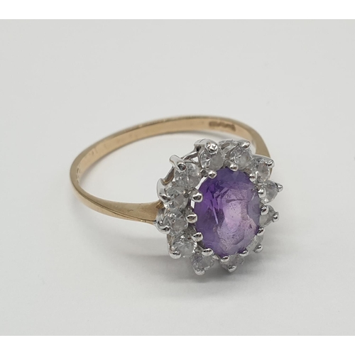 353 - 9ct gold ring having oval shaped faceted amethyst to top with clear stone surround, inclusion to ame... 