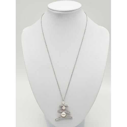 384 - Large Pearl and stone set silver pendant on a 47cm long silver chain, weight 8g and pendant size 3 x... 