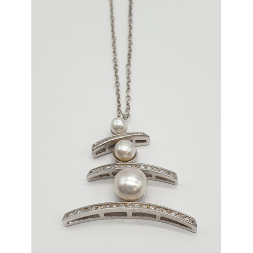 384 - Large Pearl and stone set silver pendant on a 47cm long silver chain, weight 8g and pendant size 3 x... 