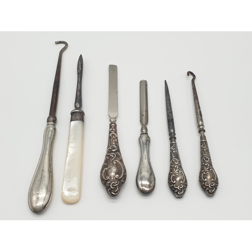 399 - A selection of late 19th/early 20th century silver handled manicure and buttoning items, all with fu... 