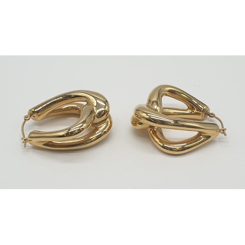 527 - A pair of 14ct gold earrings, weight 4.3g