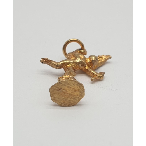 553 - Yellow metal charm/pendant of cupid, weight 1.6g and 25mm long approx