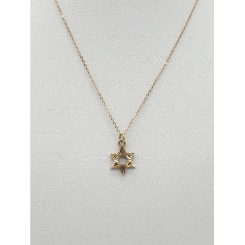 577 - 9ct gold small star of David on a 9ct 38cm chain.