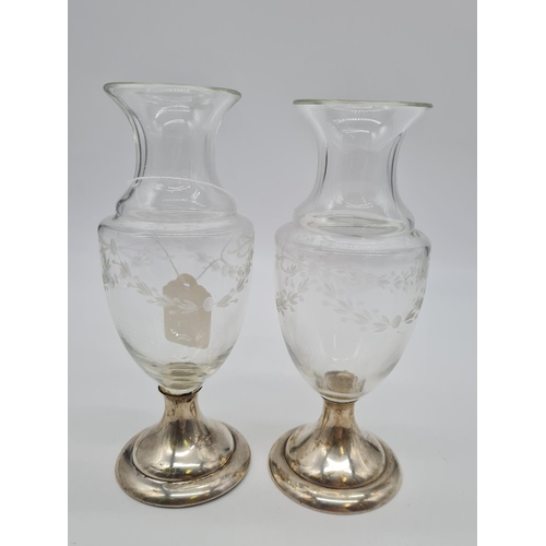 138 - Pair of silver bottomed glass vases. Weight 490g, 18cm tall.