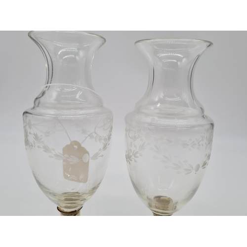 138 - Pair of silver bottomed glass vases. Weight 490g, 18cm tall.