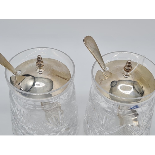 369 - Pair of cut glass silver lidded condiment jars with silver lid and silver spoon. 10cm high 483gm eac... 