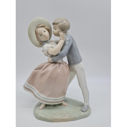 371 - Lladro boy kissing girl handmade in Spain. 27cm tall.