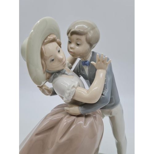 371 - Lladro boy kissing girl handmade in Spain. 27cm tall.