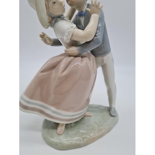 371 - Lladro boy kissing girl handmade in Spain. 27cm tall.