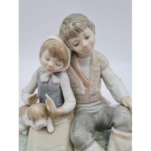 377 - Lladro boy cuddling girl, 17.5cm tall.