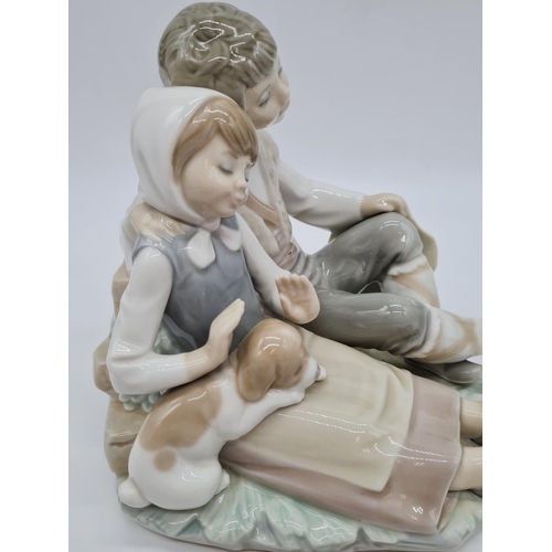 377 - Lladro boy cuddling girl, 17.5cm tall.