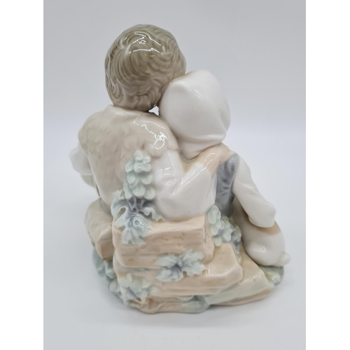 377 - Lladro boy cuddling girl, 17.5cm tall.