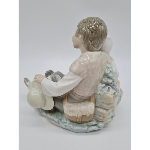 377 - Lladro boy cuddling girl, 17.5cm tall.