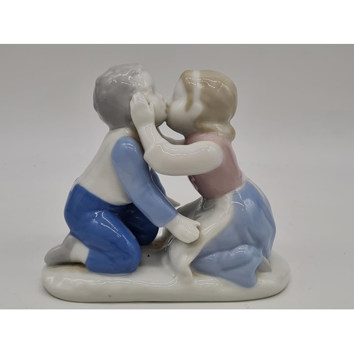 381 - German porcelain boy and girl kissing, 11cm tall.