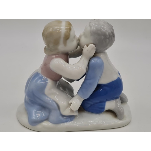 381 - German porcelain boy and girl kissing, 11cm tall.