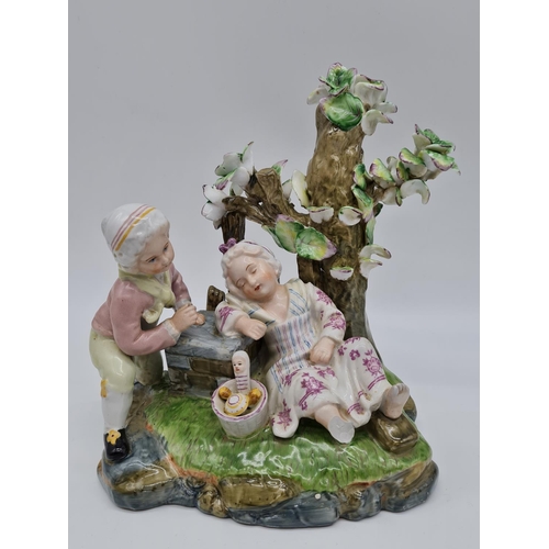 385 - Meissen ceramic statue of boy and girl. 22cm tall by 21cm wide.