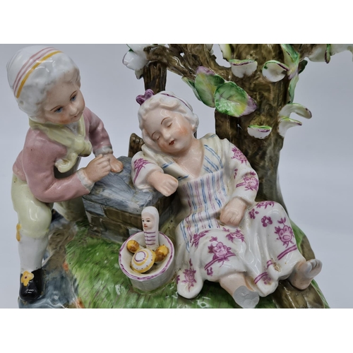 385 - Meissen ceramic statue of boy and girl. 22cm tall by 21cm wide.