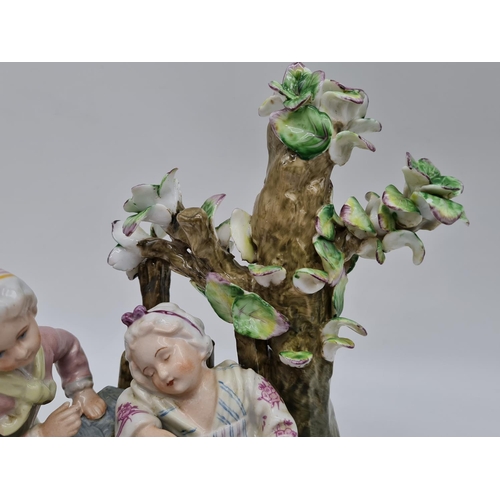 385 - Meissen ceramic statue of boy and girl. 22cm tall by 21cm wide.