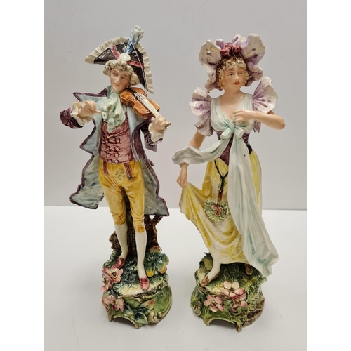 468 - Two tall ceramic figures of violin player and lady. Slight damage to to violin players hand.