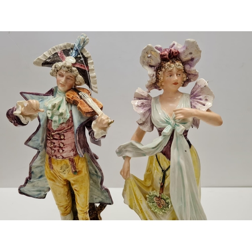 468 - Two tall ceramic figures of violin player and lady. Slight damage to to violin players hand.