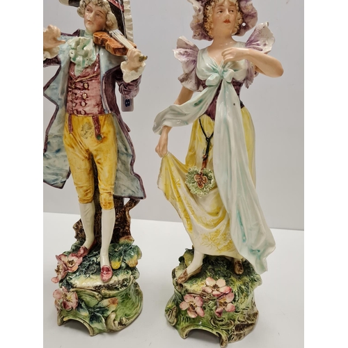 468 - Two tall ceramic figures of violin player and lady. Slight damage to to violin players hand.