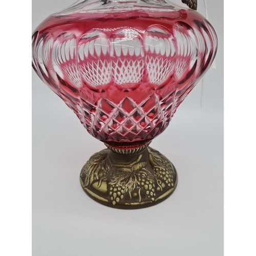 60 - Mappin & Webb Cranberry glass wine jug with ornate fruit decoration, 1.3kg total weight and 32cm tal... 