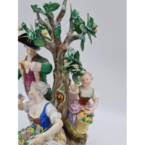 646 - Meissen statue of young family in garden. 26cm tall, width 19cm.