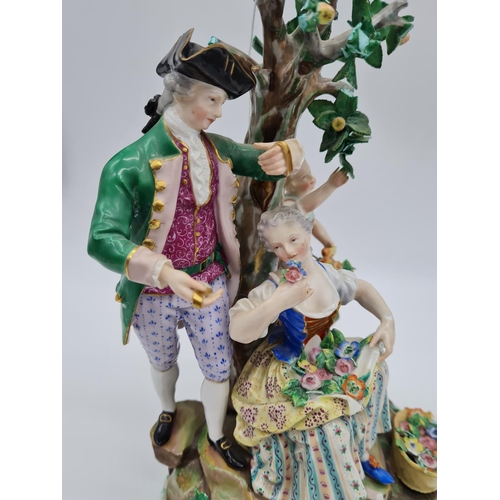 646 - Meissen statue of young family in garden. 26cm tall, width 19cm.