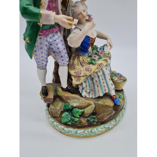 646 - Meissen statue of young family in garden. 26cm tall, width 19cm.