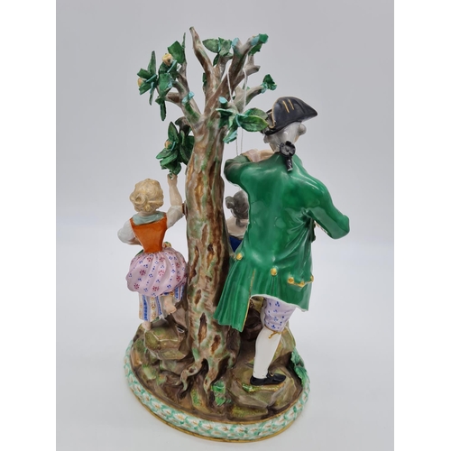 646 - Meissen statue of young family in garden. 26cm tall, width 19cm.