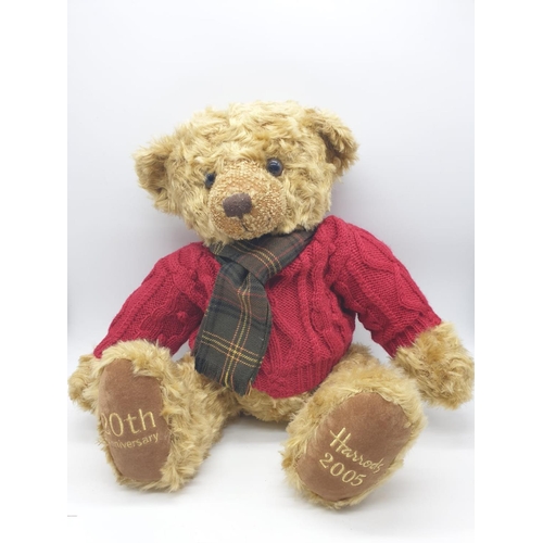 499 - Harrods 20th anniversary Teddy bear with a red knitted jumper and tartan scarf. Approx.  50cm tall.