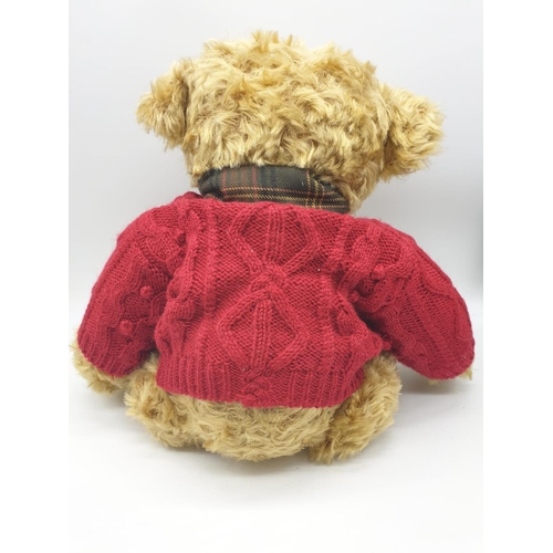 499 - Harrods 20th anniversary Teddy bear with a red knitted jumper and tartan scarf. Approx.  50cm tall.