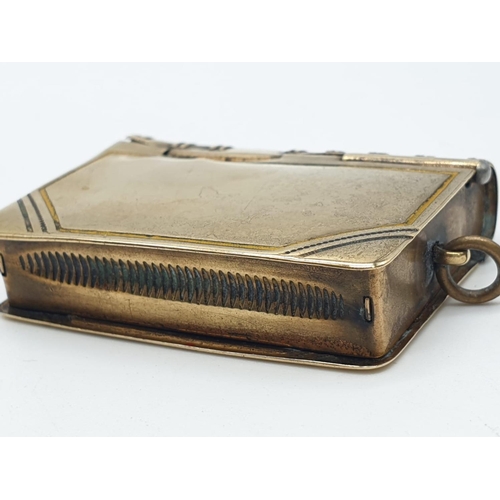 558 - Unusual double use vesta in yellow metal with a stamp holder at the back and being spring loaded, we... 