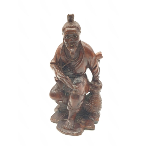 562 - Hand carved wooden figure of a Japanese honey salesman, 222g weight and 16c tall approx