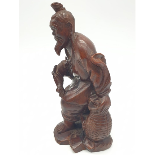 562 - Hand carved wooden figure of a Japanese honey salesman, 222g weight and 16c tall approx