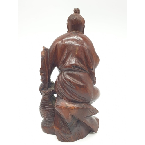 562 - Hand carved wooden figure of a Japanese honey salesman, 222g weight and 16c tall approx