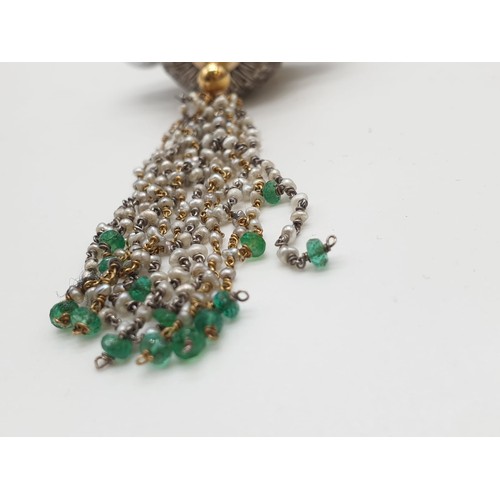 283 - An Ebony headed pendant decorated with diamonds and emerald with baroque pearl shoulders on a 68cm c... 