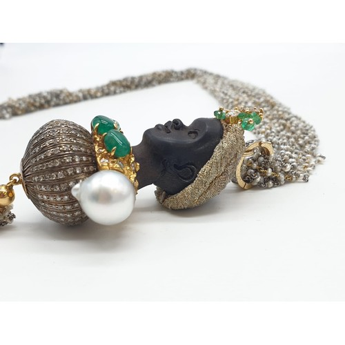 283 - An Ebony headed pendant decorated with diamonds and emerald with baroque pearl shoulders on a 68cm c... 